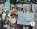 Colorful LOVE THY NEIGHBOR collage erected on neighborhood fence.