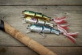 Colorful lures with the fishing rod on the wooden pier Royalty Free Stock Photo