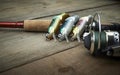 Colorful lures with the fishing rod on the wooden pier Royalty Free Stock Photo