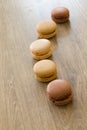 Colorful macarons in brown and earth colors. Sweet French cakes