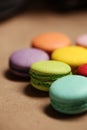 Colorful macarons cake. Closeup macaroons on color white isolated background. in coffee shop vintage color. Wooden table Royalty Free Stock Photo