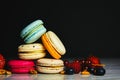 Colorful macarons cakes. Small French cakes. Sweet and colorful french macaroons. Many tasty macarons with fresh berries Royalty Free Stock Photo