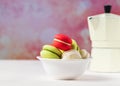 Colorful macarons cookies in white bowl on pastel background, copy space Royalty Free Stock Photo