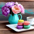 Colorful macarons, cup of coffee and pink flowers on a wooden table