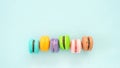 Colorful macarons dessert on blue background Royalty Free Stock Photo