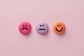 Colorful macarons with happy, neutral and sad faces. Customer rating and evaluation