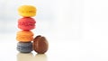 Colorful macarons pile on white background, close up view