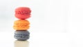 Colorful macarons pile on white background, close up view