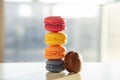 Colorful macarons pile on white background, close up view