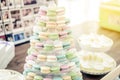 Colorful macarons on pyramid-shaped plastic stand