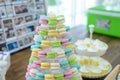 Colorful macarons on pyramid-shaped plastic stand