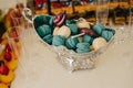 Colorful macarons on pyramid-shaped plastic tower stand as part of candy bar sweet table Royalty Free Stock Photo