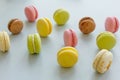 Colorful macarons on trendy pastel gray paper. tasty pink, yello