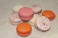 Colorful macaroon biscuits on textile background