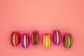 Colorful macaroons cakes on orange background