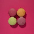 Colorful macaroons cakes on pink background. Flat lay Royalty Free Stock Photo
