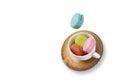 Colorful macaroons  floating on a tea cup and a ceramic plate Royalty Free Stock Photo