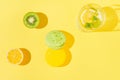 macaroons with glass of lemonade and fruits on sulit yellow background . Summer refreshment concept. Top view. Flat lay Royalty Free Stock Photo