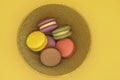 Colorful macaroons cakes on orange background