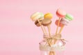 Colorful macaroons on wooden sticks