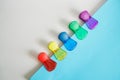 Colorful magentic pins or clips hold a blue piece of paper on magnetic board or refrigerator door. Space for text. Paper note for