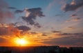 Colorful Magic Sunset. Roofs of city houses during sunrise. Birds flying in the sky. Dark smoke coming from the thermal power Royalty Free Stock Photo