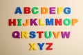 Colorful magnetic letters on beige, flat lay. Alphabetical order Royalty Free Stock Photo