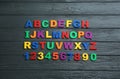 Colorful magnetic letters and numbers on wooden background, flat lay Royalty Free Stock Photo