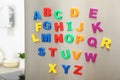 Colorful magnetic letters on refrigerator door Royalty Free Stock Photo