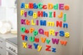 Colorful magnetic letters on refrigerator door Royalty Free Stock Photo