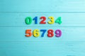 Colorful magnetic numbers on blue wooden background, flat lay Royalty Free Stock Photo