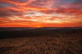 Colorful magnificent sunset in countryside above hills and fields, beauty nature background Royalty Free Stock Photo