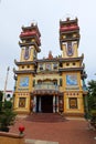 Colorful main facade of the Cao Dai Taoist temple. Hoi An, Vietnam