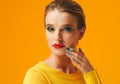 Colorful makeup woman red lips in yellow clothes on color happy summer fashion background manicured nails Royalty Free Stock Photo