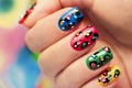 Colorful manicure close up with dots.