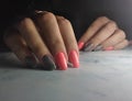 Colorful manicure with pink glossy finish.