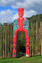 A colorful Maori gateway on the edge of a garden, New Zealand