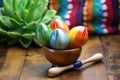 colorful maracas on a rustic wooden table, with a succulent cactus in the background
