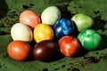 Colorful marbled easter eggs arranged on a green surface with soil Royalty Free Stock Photo