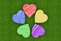 Colorful marker drawing hearts over green grass