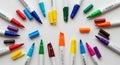 Colorful markers are arranged in a circular pattern on a white background. The markers have white Royalty Free Stock Photo