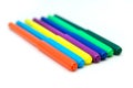 Colorful markers lying in a row on a white background. Art and education