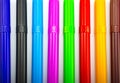 Colorful markers in a row, isolated on a white Royalty Free Stock Photo