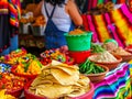 A colorful market with bowls of tortillas and other food