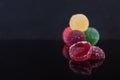 Colorful marmalade isolated on dark background. Delicious jujube balls Royalty Free Stock Photo