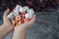 Colorful marshmallows and jellybeans in the hand of a man