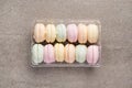 Colorful marshmallows in plastic box on concrete background Royalty Free Stock Photo