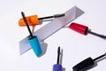 Colorful mascara wands on white background with risers and copy space Royalty Free Stock Photo