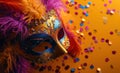 a colorful mask sits on an orange background