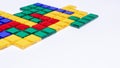 Colorful matching blocks like tetris on white background, high contrast colours, red blue yellow and green transparent tiles Royalty Free Stock Photo